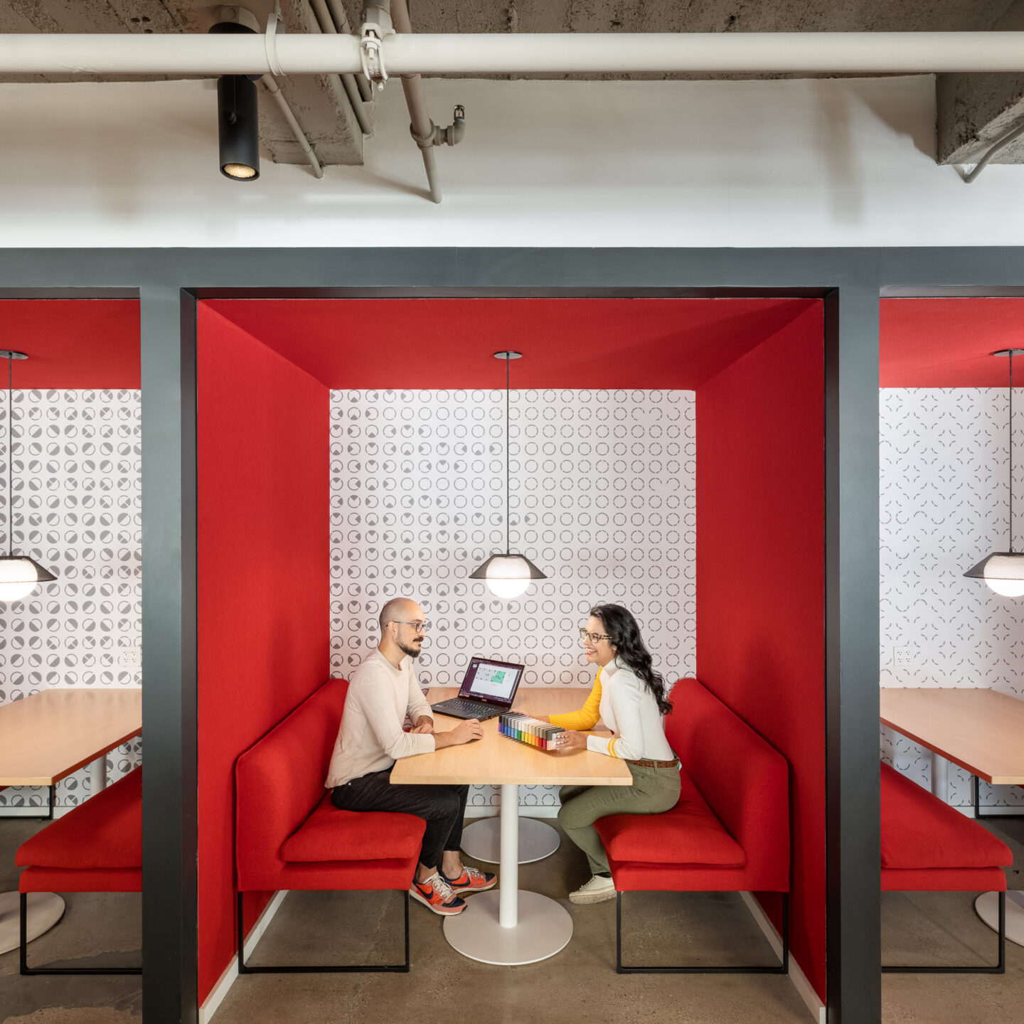 Two people work at a table in a cafe setting